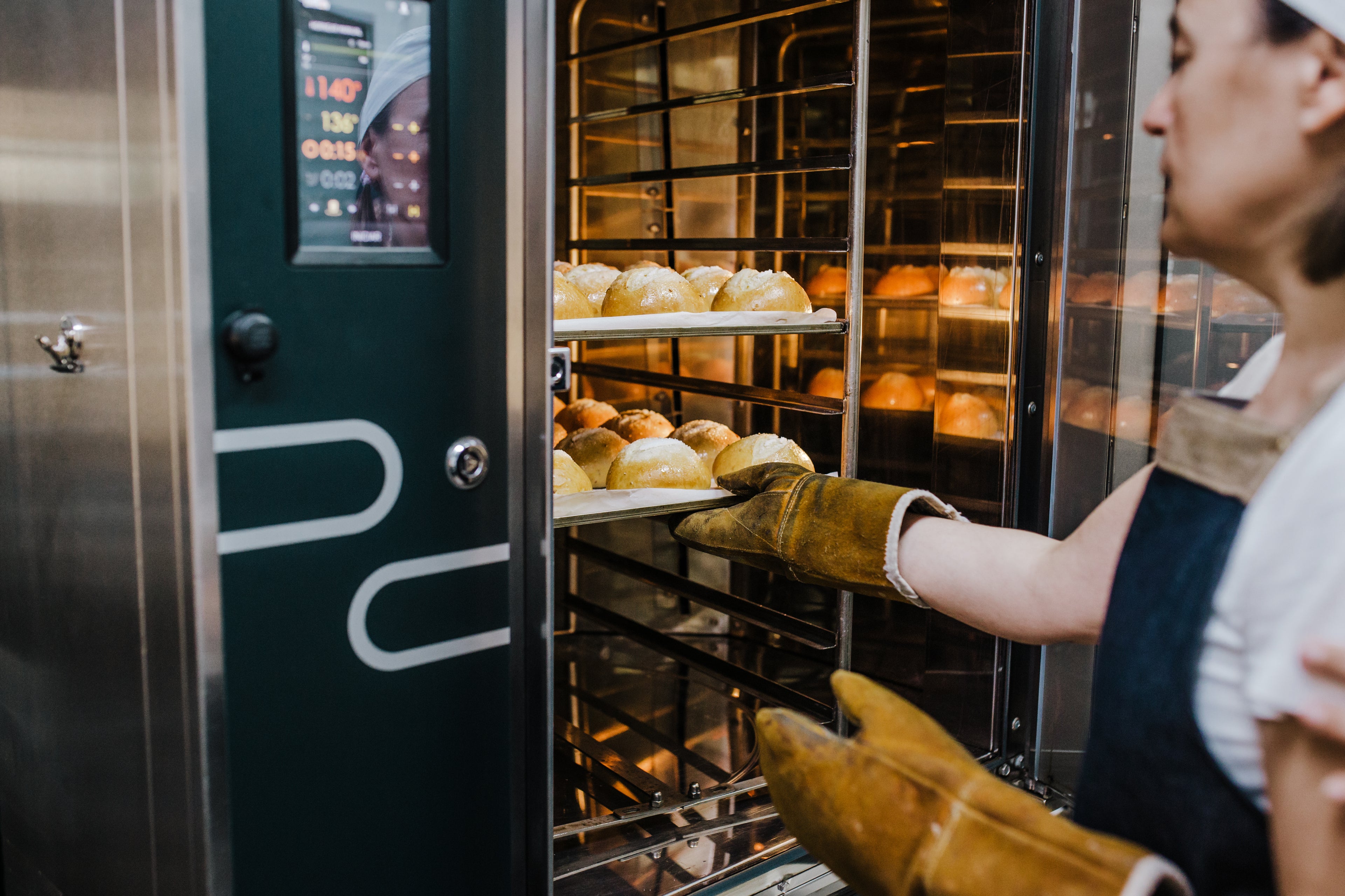 Person baking using an industrial/commercial oven